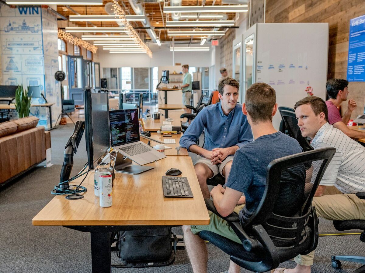 Small business team reviewing work around a table