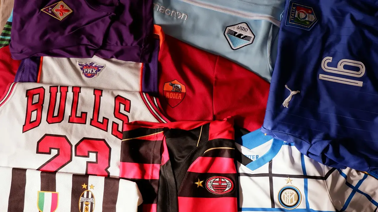A mixed stack of colorful team jerseys