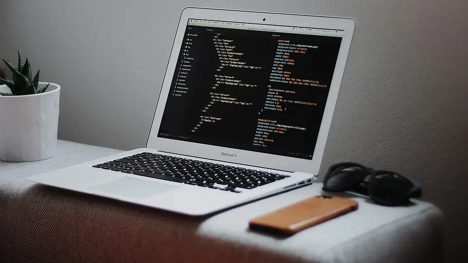A laptop displaying structured data on a desk