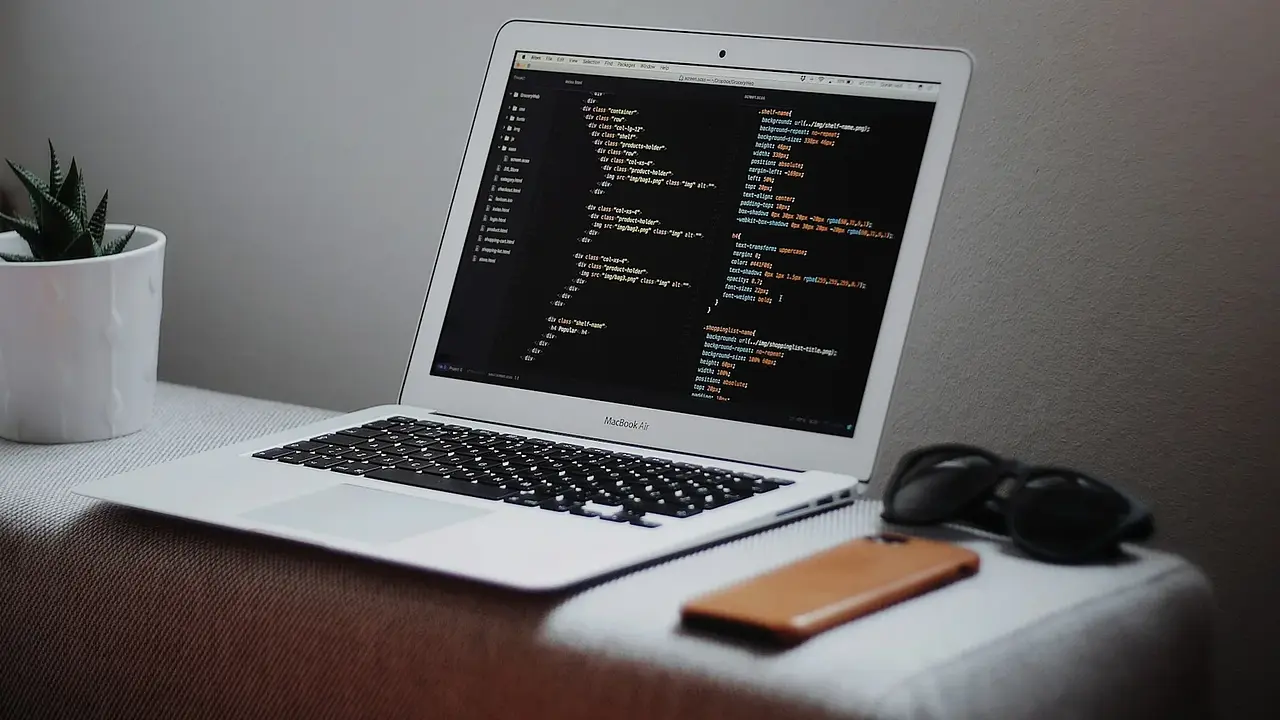 A laptop displaying structured data on a desk