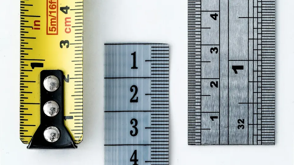 Several rulers and measuring tapes showing different scales