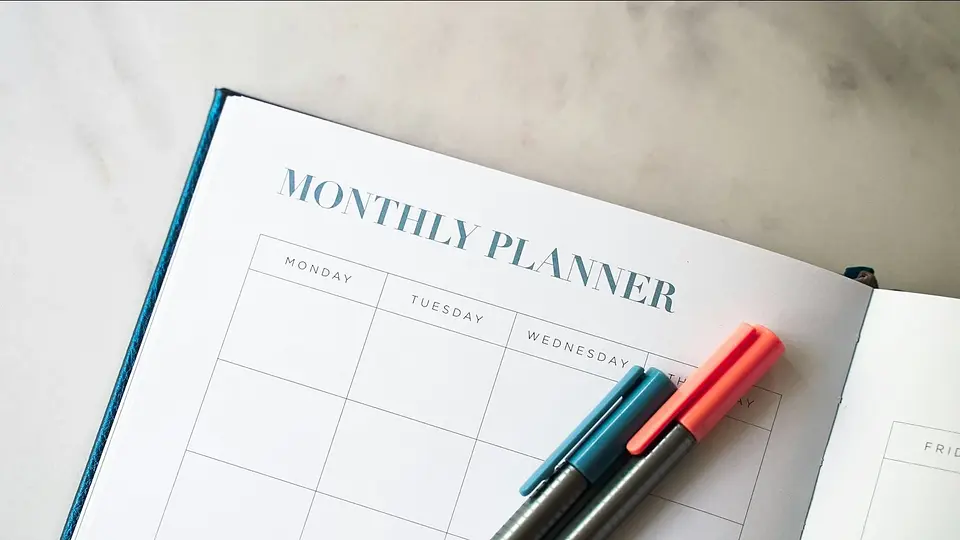 A monthly planner with two pens ready for long-term planning